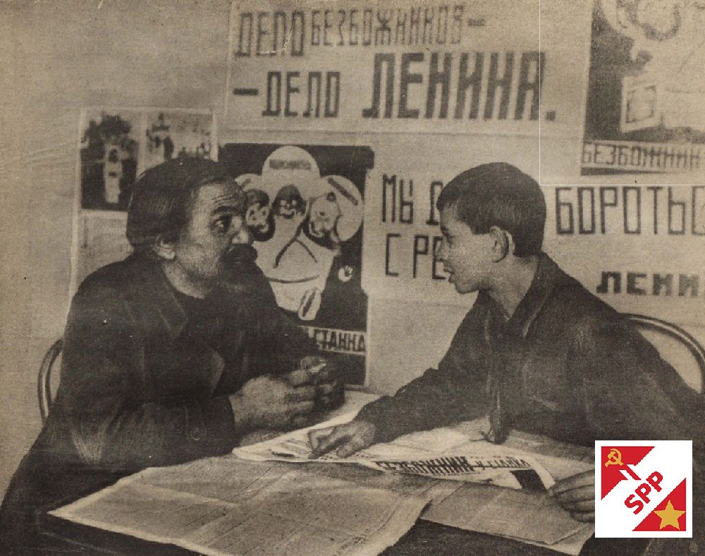 Soviet workers having a conversation in front of a ussr poster in the  canteen of their factory, 1927